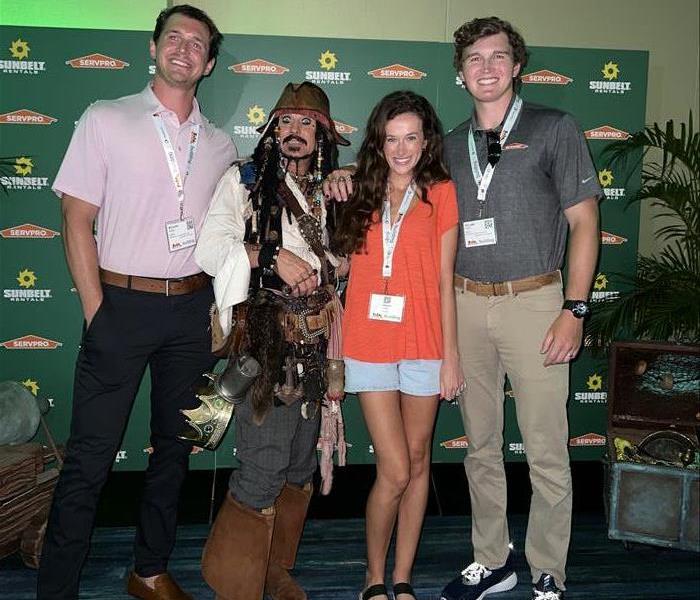 A photo of three Servpro people with a pirate